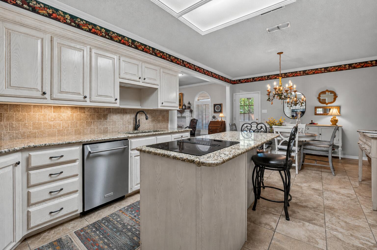 7402 95th Street Lubbock, TX 79424 - Photo 15 of 43 a kitchen with granite countertop a sink and cabinets