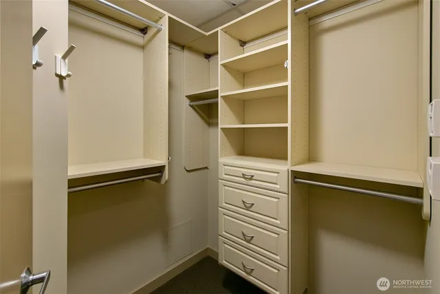 a view of walk in closet with empty racks