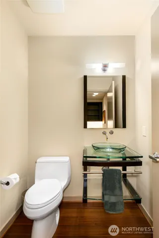 a bathroom with a toilet sink and mirror