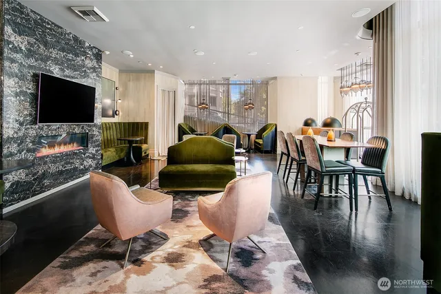 a living room with furniture a flat screen tv and kitchen view