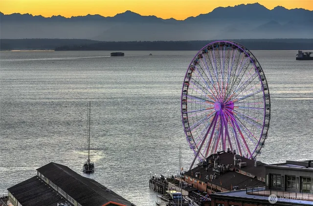 a bedroom with a bed and a chair with the wooden floor