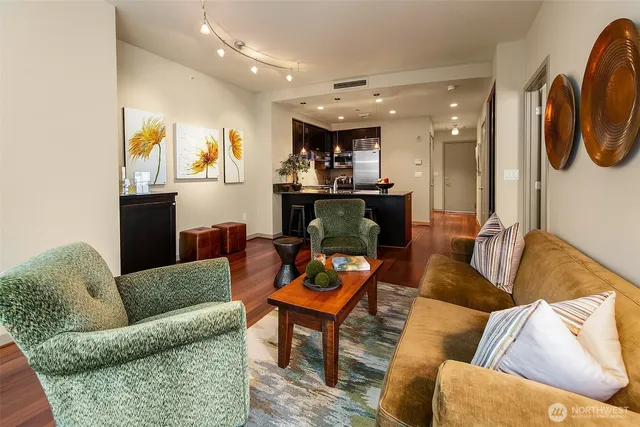 a living room with furniture and wooden floor
