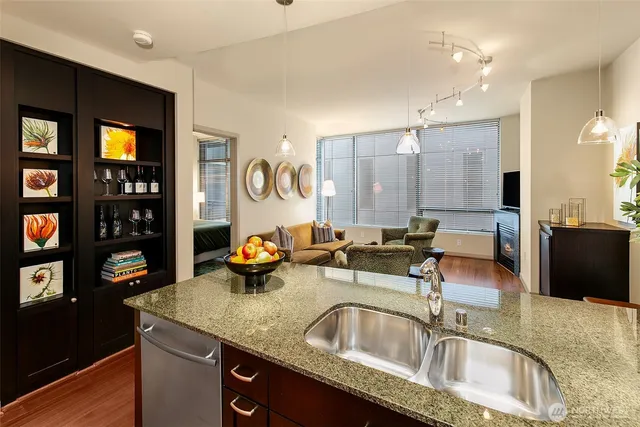 a kitchen with granite countertop a sink and a stove top oven