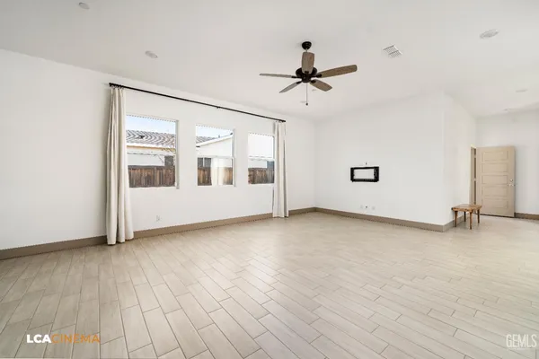 a view of a livingroom with a ceiling fan and window