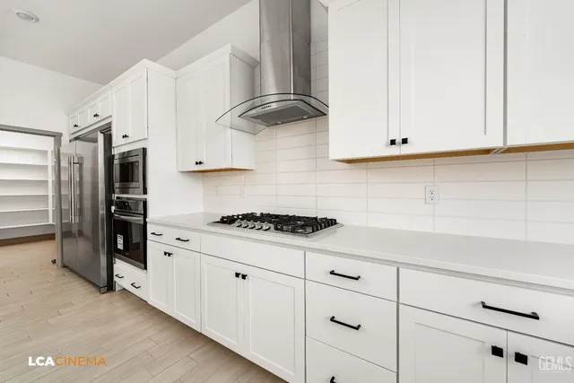 a kitchen with stainless steel appliances granite countertop a sink and a stove
