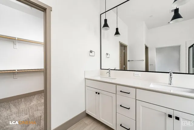 a bathroom with a double vanity sink and mirror