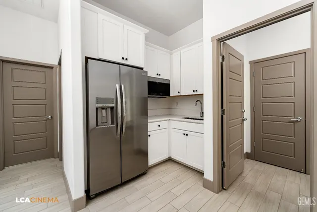 a kitchen with a refrigerator and a stove