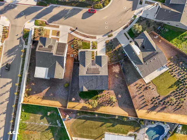 an aerial view of a house with a swimming pool
