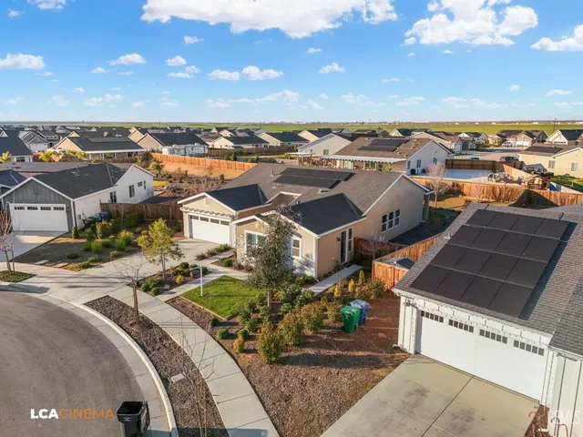 an aerial view of residential houses with outdoor space