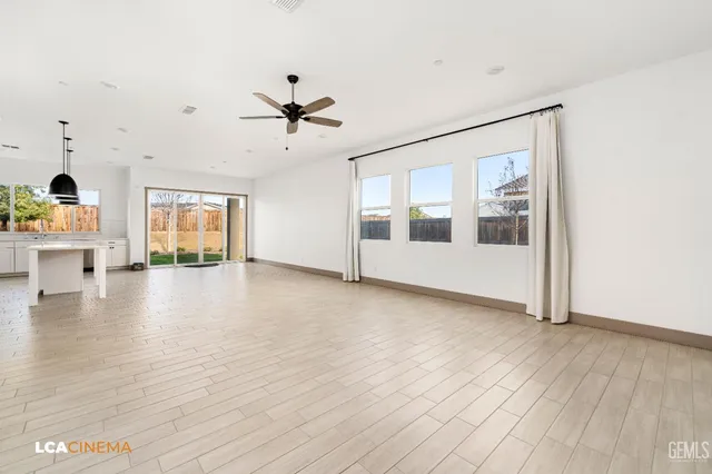 a view of a livingroom with wooden floor and white walls