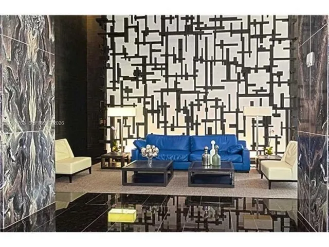 a view of living room filled with furniture and rug