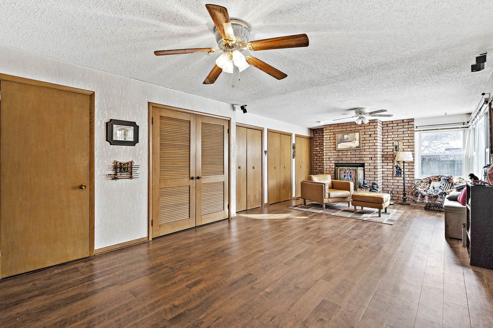 9 Strasma S Drive Kankakee, IL 60901 - Photo 12 of 16 a view of a livingroom with furniture a ceiling fan and wooden floor