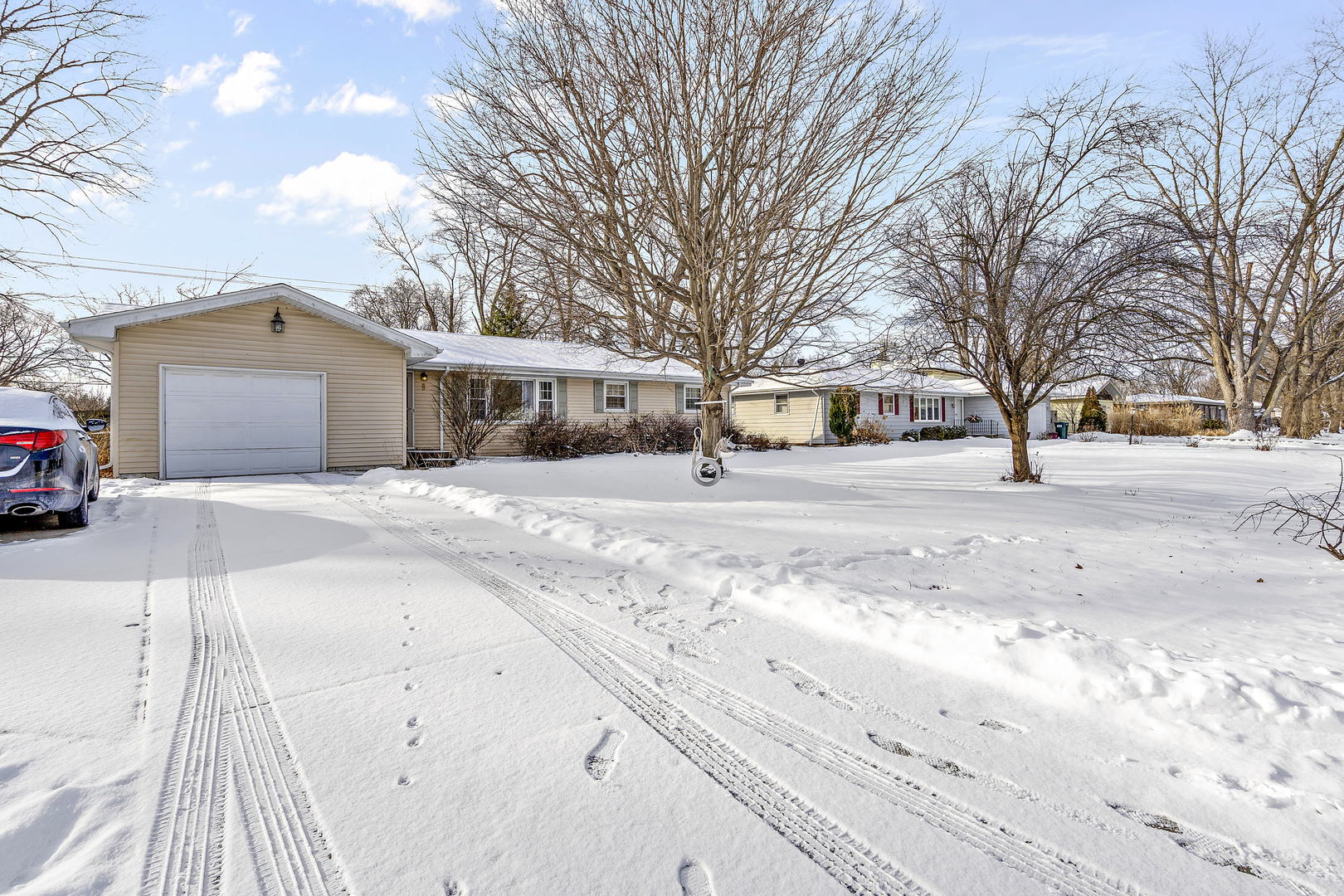 9 Strasma S Drive Kankakee, IL 60901 - Photo 2 of 16 a front view of a house with a yard covered in snow