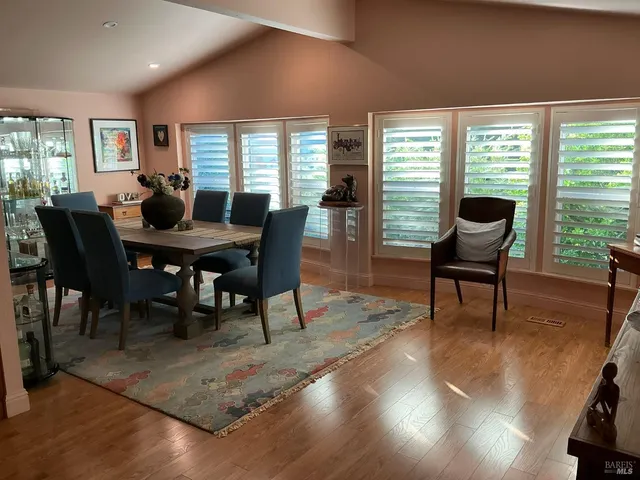 a view of a dining room with furniture window and wooden floor