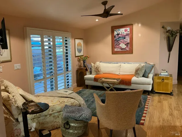 a bedroom with furniture and a large window