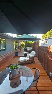 a dining room with furniture and a potted plant