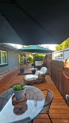 a dining room with furniture and a potted plant
