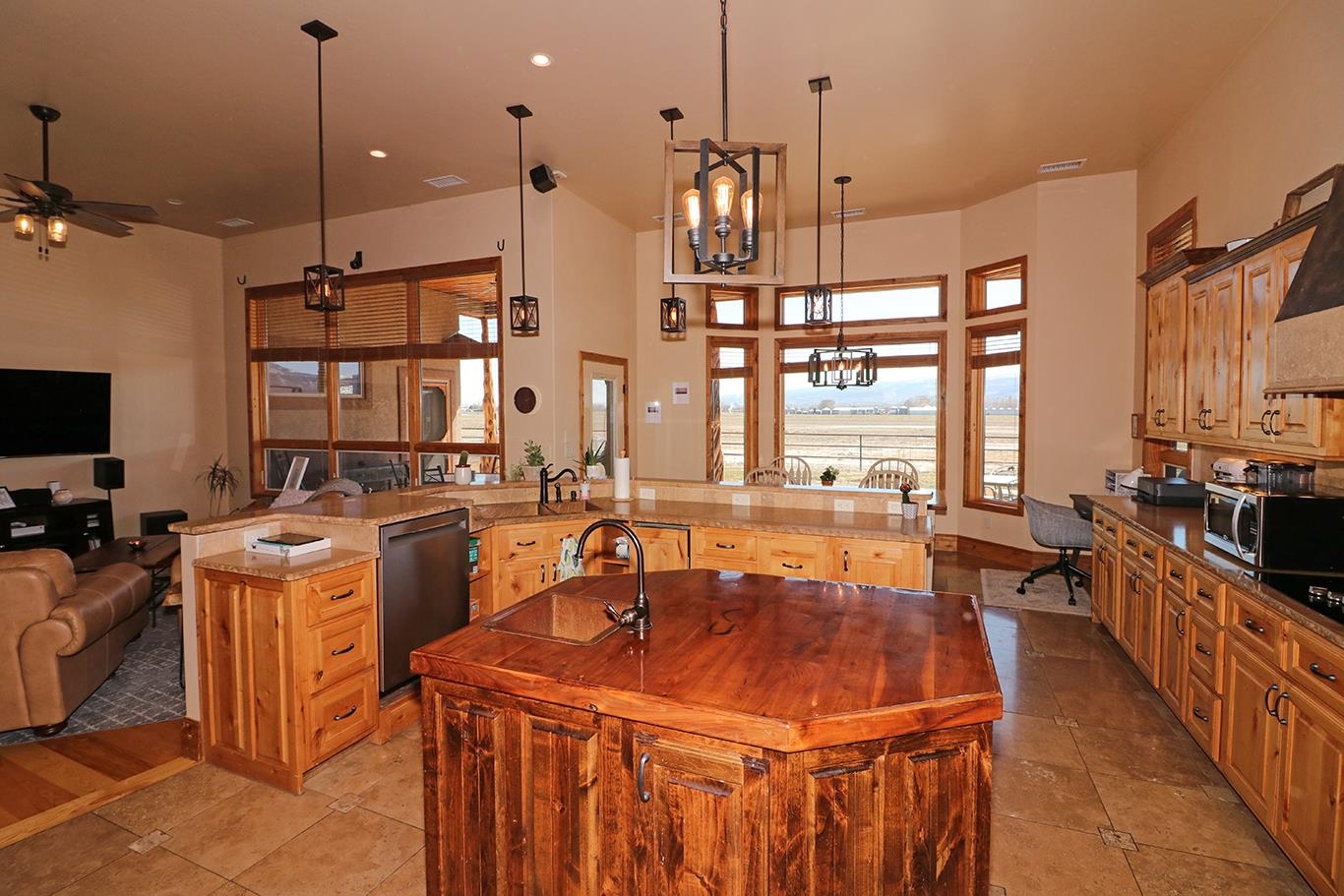 880 23 Road Grand Junction, CO 81505 - Photo 8 of 42 a room with stainless steel appliances kitchen island granite countertop a stove a sink and a granite counter tops with white cabinets