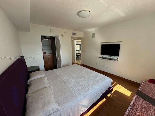 31 Southeast 5th Street, Unit 1908 Miami, FL 33131 - Photo 12 of 43 a bedroom with a bed and a flat screen tv