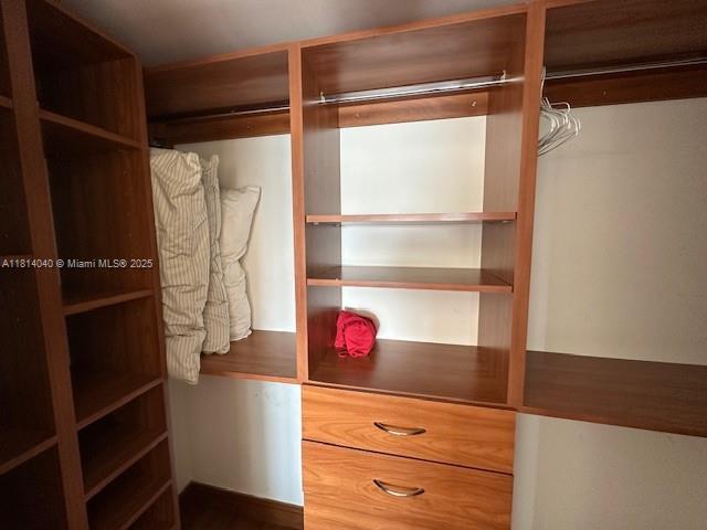 31 Southeast 5th Street, Unit 1908 Miami, FL 33131 - Photo 13 of 43 a view of walk in closet with clothes and shoes