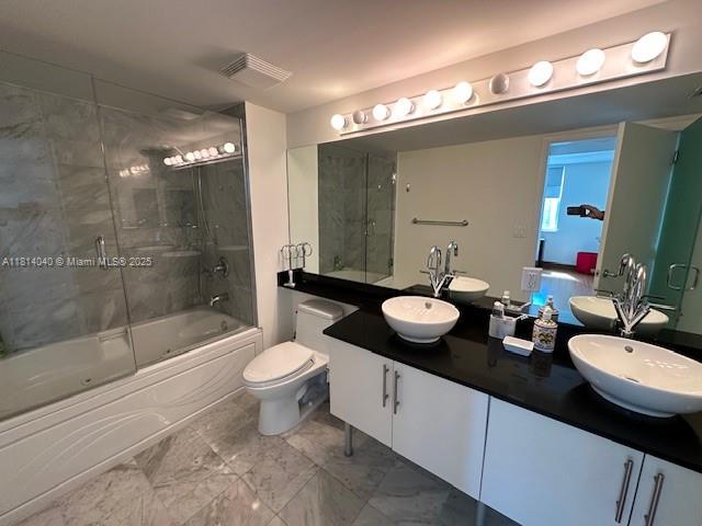 31 Southeast 5th Street, Unit 1908 Miami, FL 33131 - Photo 14 of 43 a bathroom with a granite countertop sink a toilet a mirror and shower