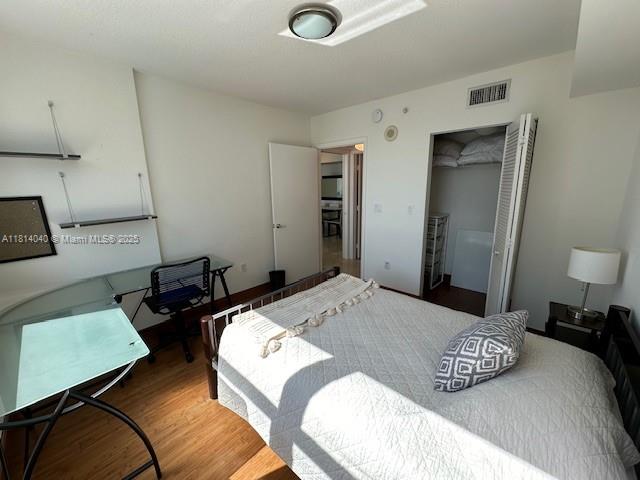 31 Southeast 5th Street, Unit 1908 Miami, FL 33131 - Photo 17 of 43 a bedroom with a bed and a chair