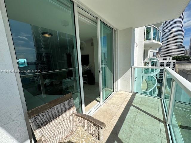 31 Southeast 5th Street, Unit 1908 Miami, FL 33131 - Photo 21 of 43 a room with table chair and glass door