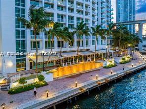 31 Southeast 5th Street, Unit 1908 Miami, FL 33131 - Photo 30 of 43 a view of a swimming pool with a table and chairs