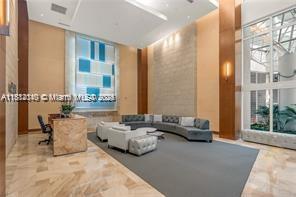 31 Southeast 5th Street, Unit 1908 Miami, FL 33131 - Photo 32 of 43 a living room with furniture and large windows