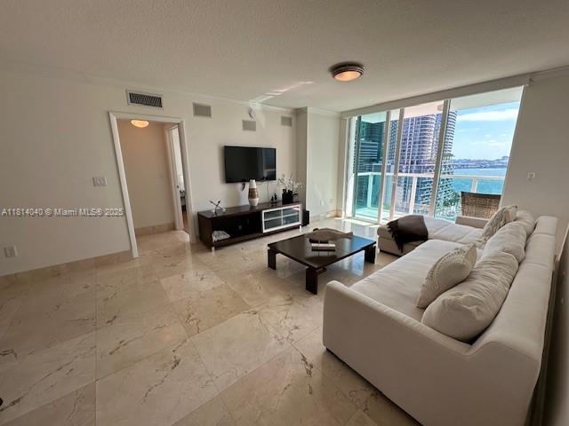 31 Southeast 5th Street, Unit 1908 Miami, FL 33131 - Photo 4 of 43 a living room with furniture and a flat screen tv