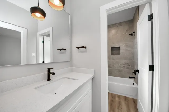 a bathroom with a sink a toilet and shower