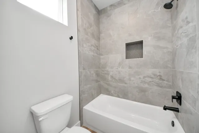 a bathroom with a toilet and bathtub