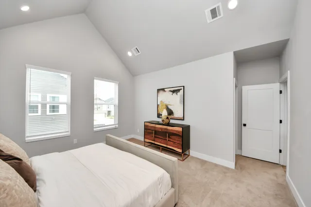 a bedroom with a bed and window