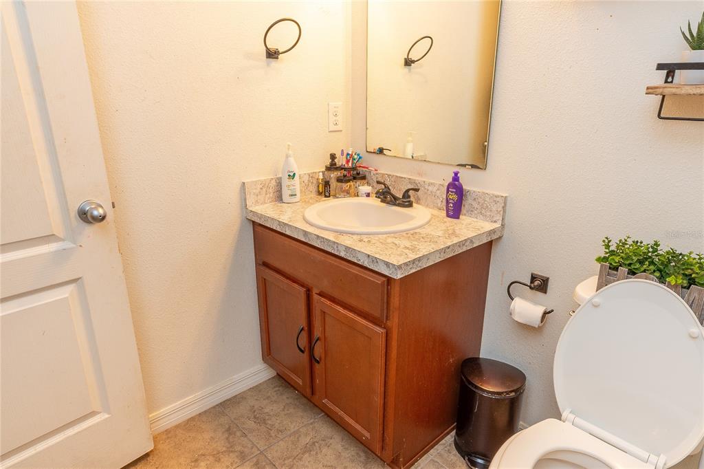 4563 Orchard Grove Road St. Cloud, FL 34772 - Photo 48 of 51 a bathroom with a sink toilet and mirror