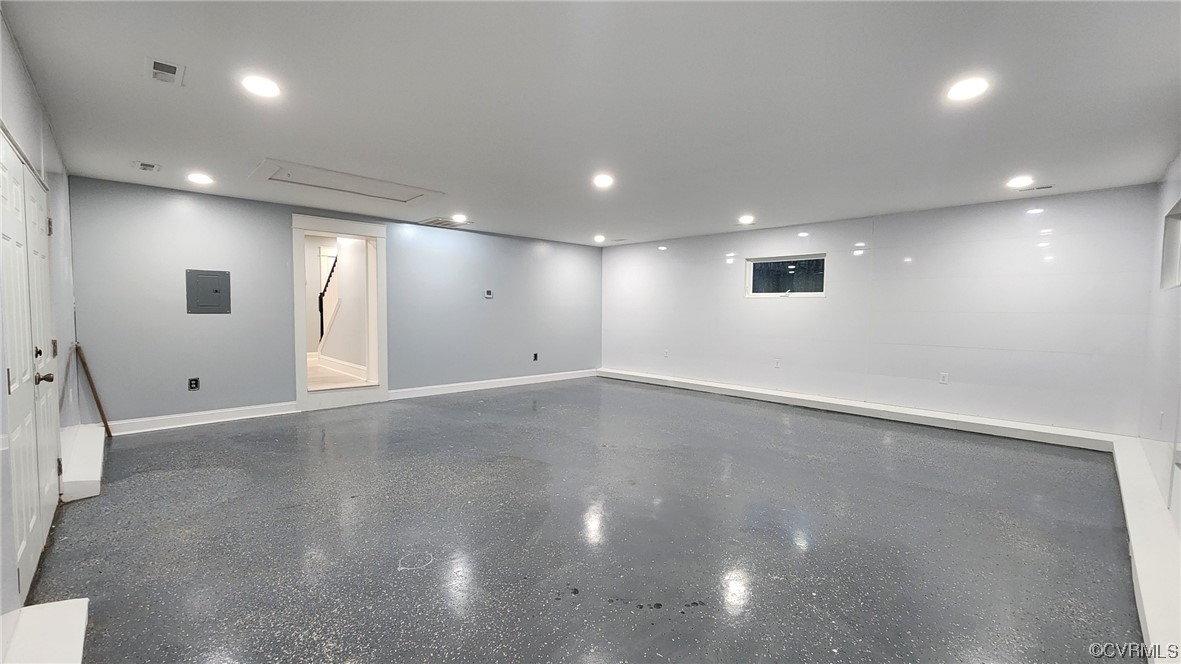 741 Waltons Store Road Louisa, VA 23093 - Photo 12 of 42 an empty room with a projector and windows