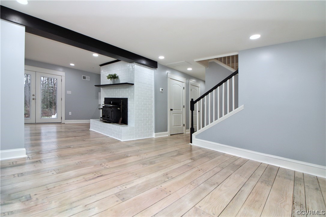 741 Waltons Store Road Louisa, VA 23093 - Photo 7 of 42 a view of an empty room with wooden floor and a fireplace