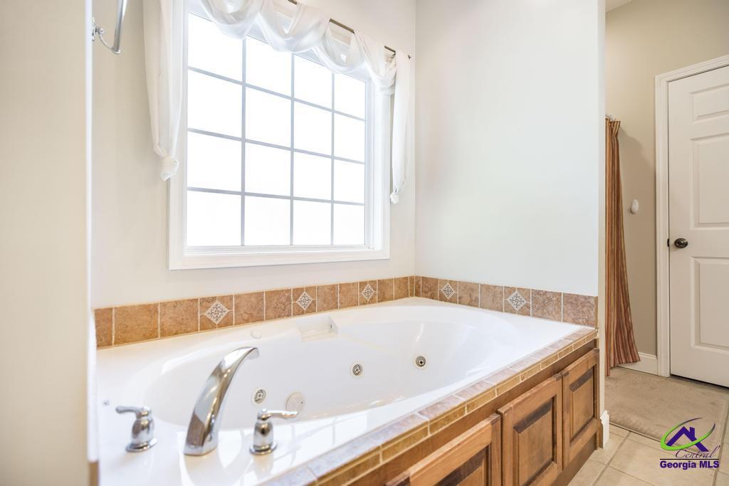 204 Smith Road Haddock, GA 31033 - Photo 23 of 51 a bathroom with a tub and a window