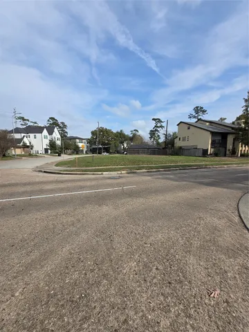 a view of a town with big trees