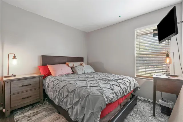 a bed sitting in a bedroom next to a window