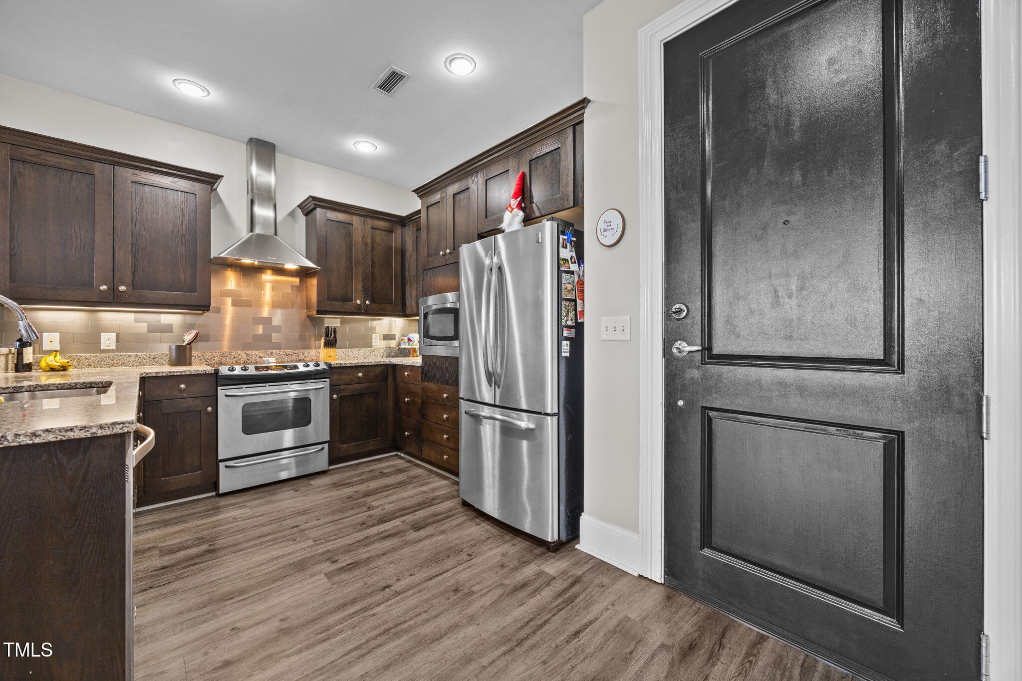 400 West North Street, Unit 1028 Raleigh, NC 27603 - Photo 14 of 30 a kitchen with granite countertop stainless steel appliances a refrigerator and cabinets