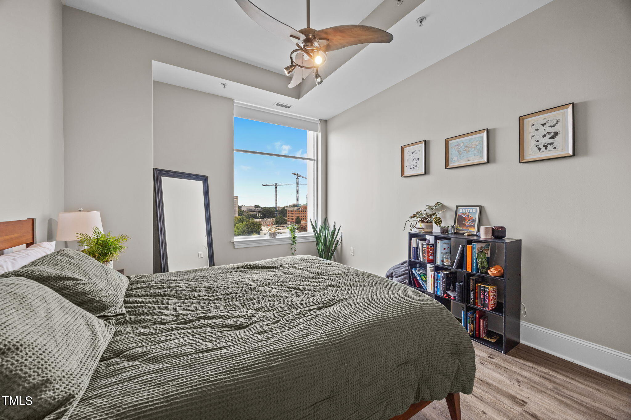 400 West North Street, Unit 1028 Raleigh, NC 27603 - Photo 20 of 30 a bedroom with a bed a table and book shelf