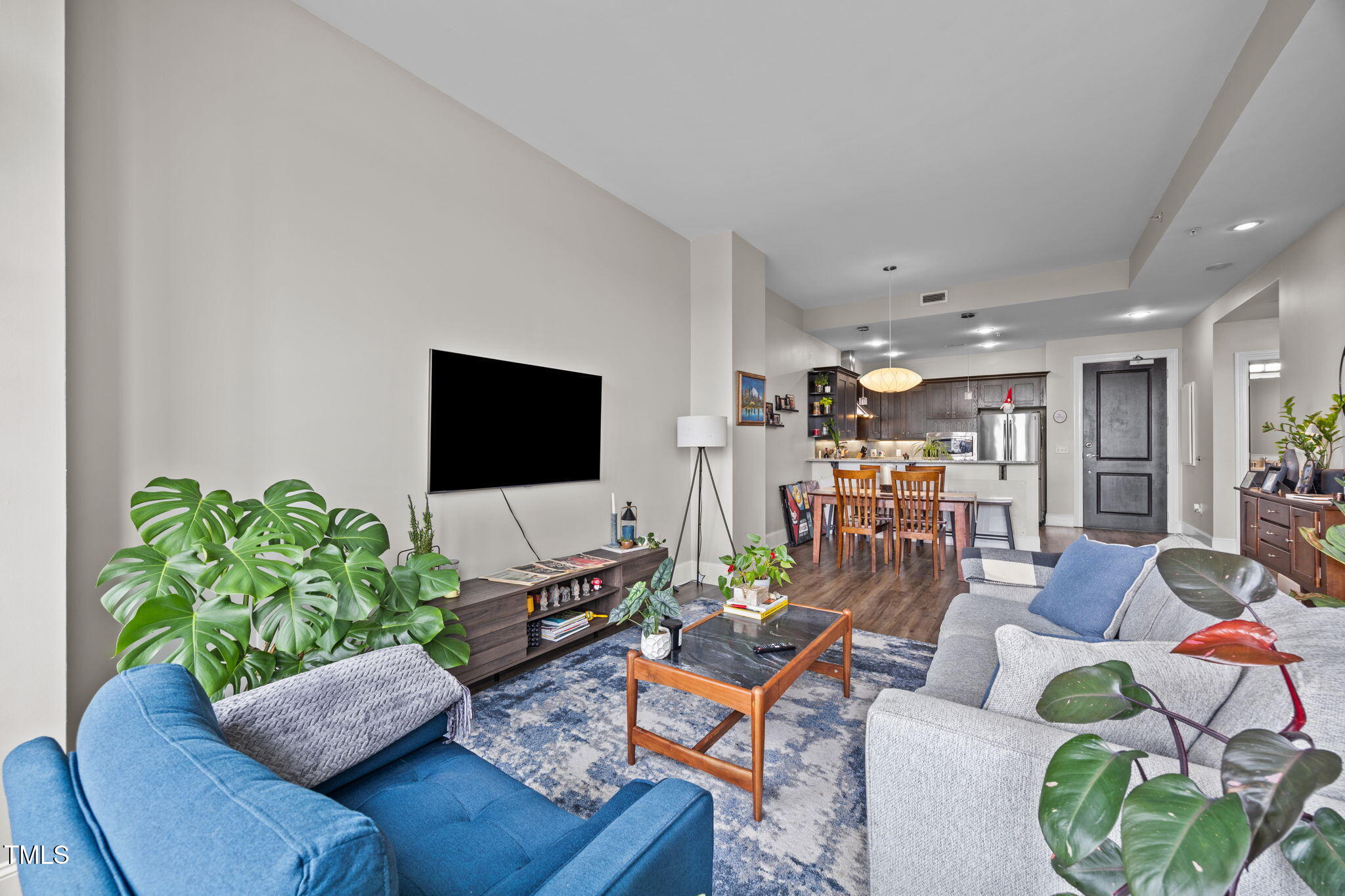 400 West North Street, Unit 1028 Raleigh, NC 27603 - Photo 28 of 30 a living room with furniture and a flat screen tv