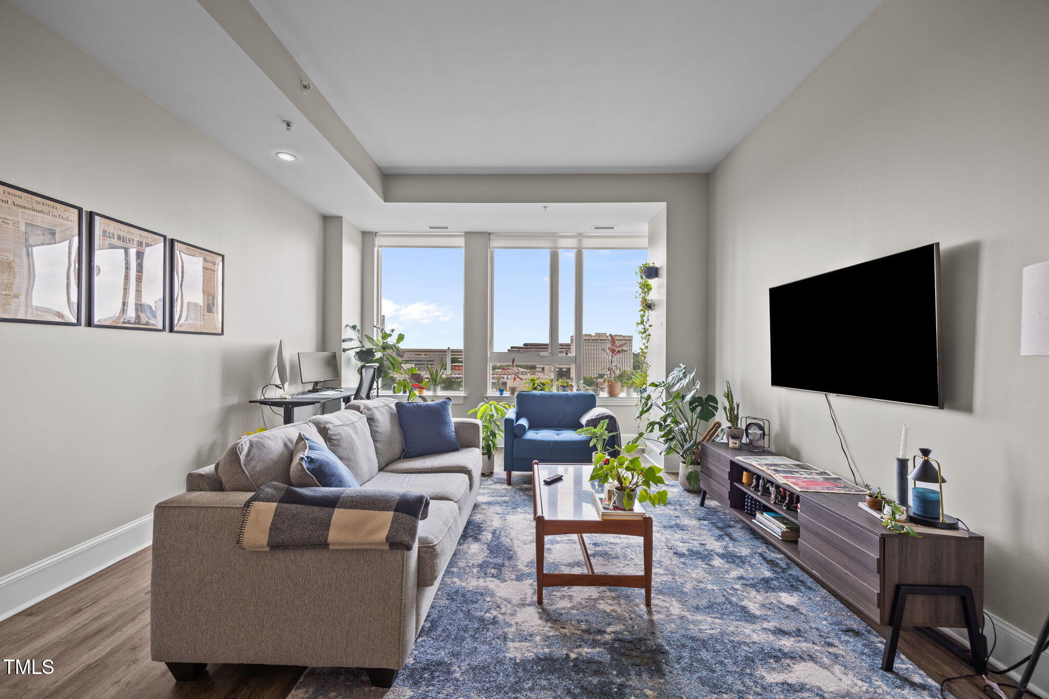 400 West North Street, Unit 1028 Raleigh, NC 27603 - Photo 3 of 30 a living room with furniture and a flat screen tv