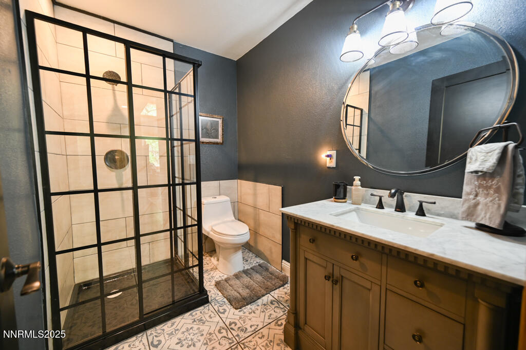 1147 Autumn Hills Road Gardnerville, NV 89460 - Photo 24 of 53 a bathroom with a sink toilet and a mirror