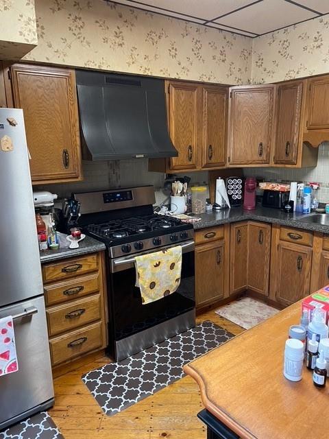 3401 Universal Road Pittsburgh, PA 15235 - Photo 12 of 35 a kitchen with stainless steel appliances a stove a sink a refrigerator and cabinets