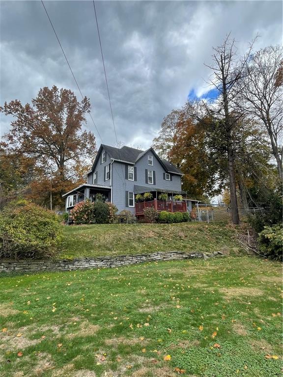 3401 Universal Road Pittsburgh, PA 15235 - Photo 3 of 35 a front view of a house with a yard and trees