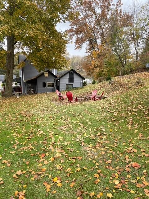 3401 Universal Road Pittsburgh, PA 15235 - Photo 6 of 35 a yellow and red house covered with tall trees