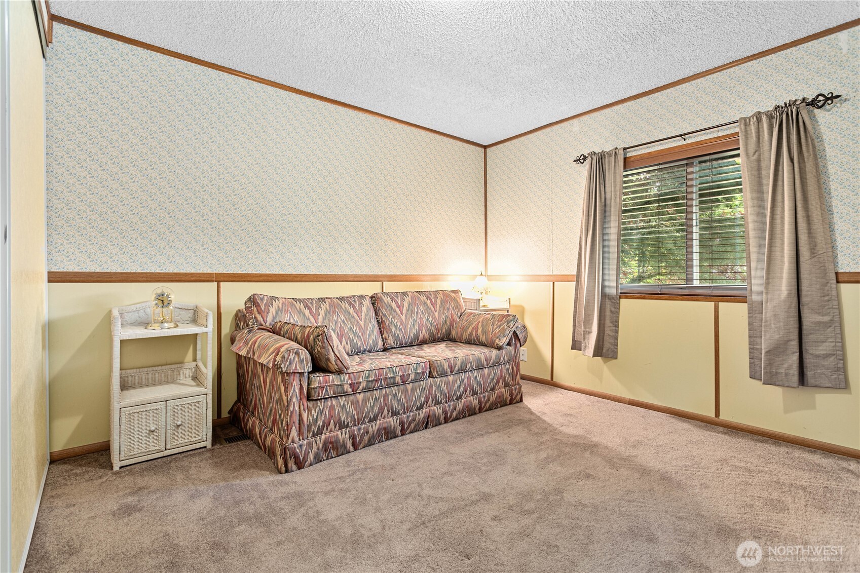 5459 Noon Road Bellingham, WA 98226 - Photo 17 of 40 a living room with a couch and a dresser next to a window