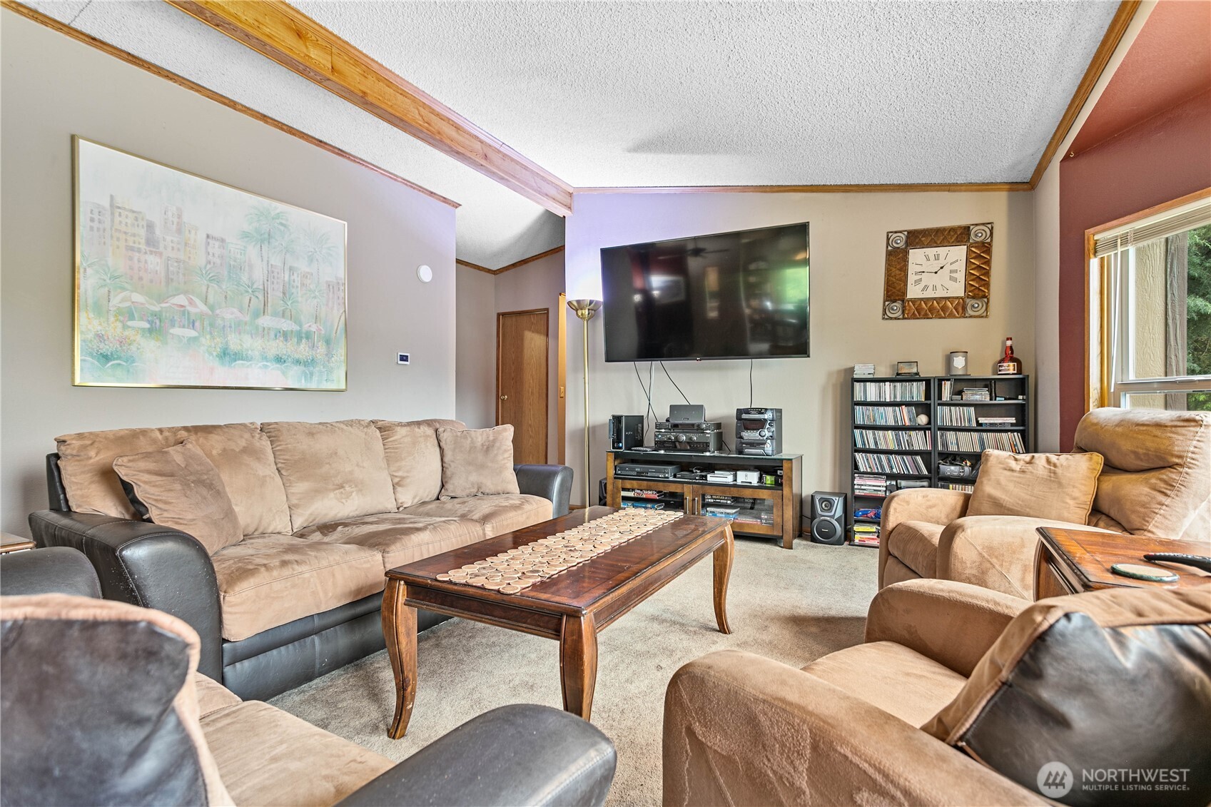 5459 Noon Road Bellingham, WA 98226 - Photo 5 of 40 a living room with furniture a flat screen tv and a fireplace