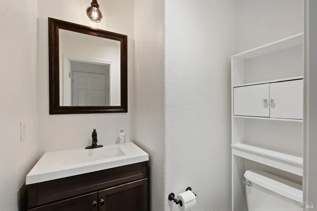 a kitchen with kitchen island granite countertop a sink appliances and cabinets